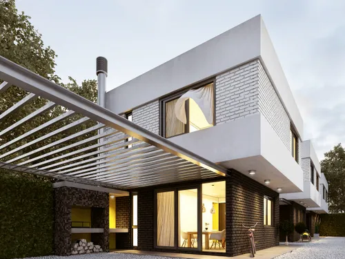 Pergola bioclimatique adossée à une maison en briques, éclairage chaleureux en soirée