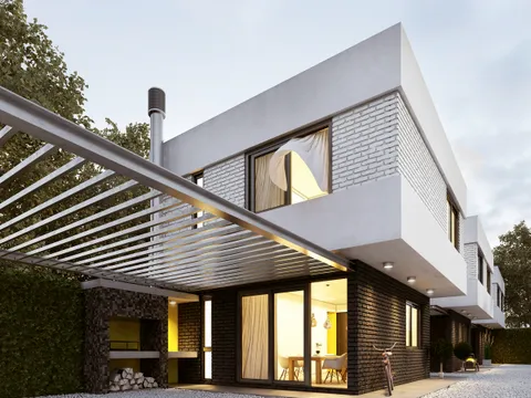 Pergola bioclimatique adossée à une maison en briques, éclairage chaleureux en soirée